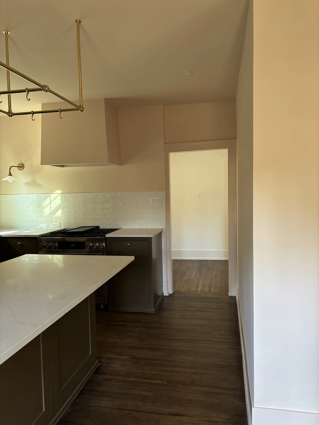 Kitchen finishes — Cabinetry, stone counters, and brass details.