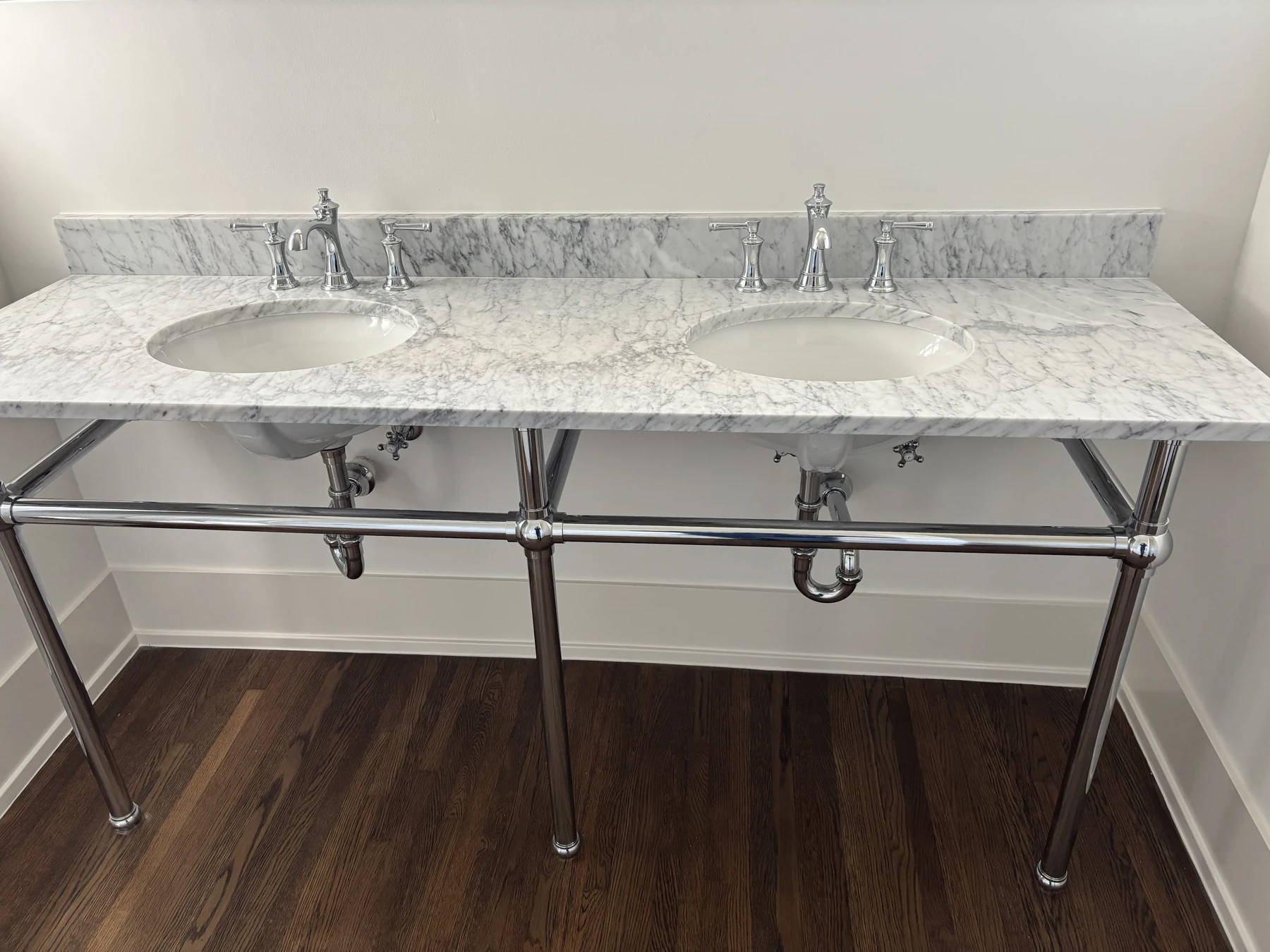 Double vanity — Marble surfaces and chrome fixtures.